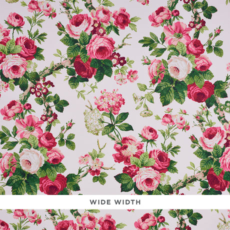 Nancy Floral wallpaper in Rose by Schumacher, featuring exuberant pink and red rose blossoms with green foliage on a light background.