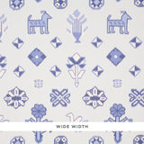 Chuska Warp Print wallpaper in blue with ikat-style horses, birds, and flowers by Schumacher, shown in a bathroom setting.