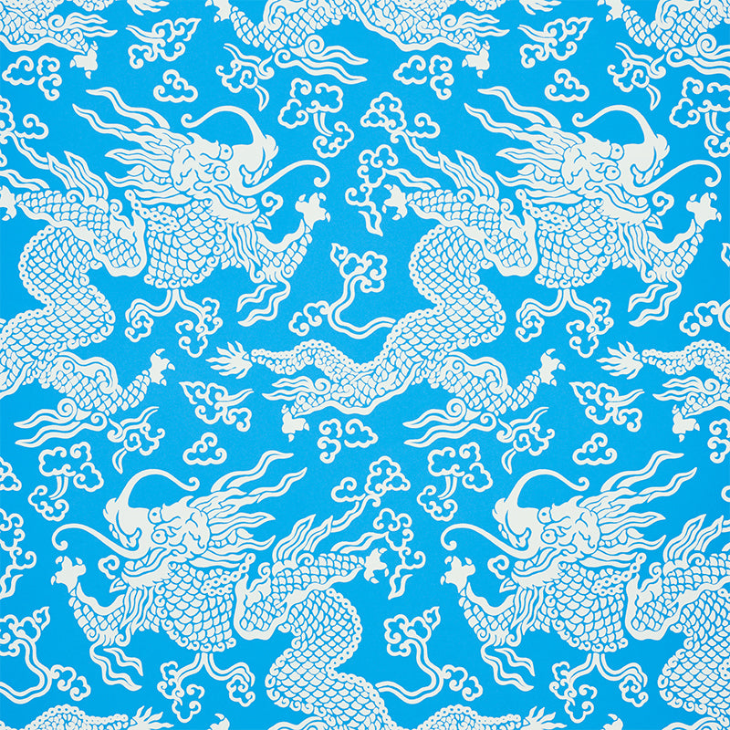 Blue and white dragon damask wallpaper with Art Deco chinoiserie design by Schumacher, styled in a modern bedroom setting.