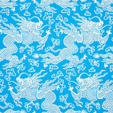 Blue and white dragon damask wallpaper with Art Deco chinoiserie design by Schumacher, styled in a modern bedroom setting.