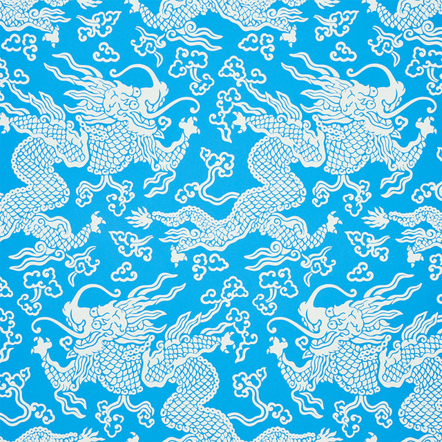 Blue and white dragon damask wallpaper with Art Deco chinoiserie design by Schumacher, styled in a modern bedroom setting.