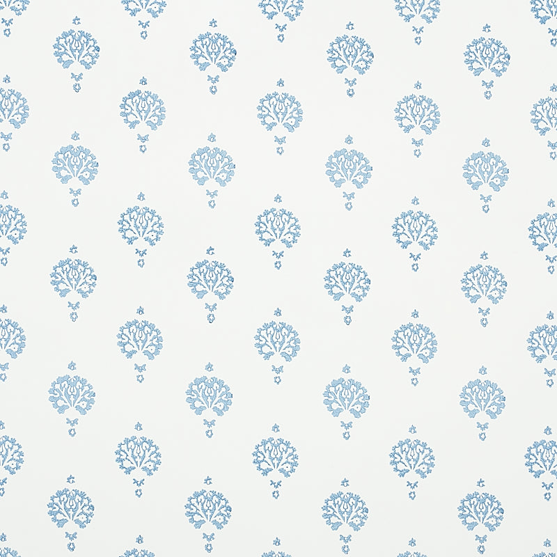 Dahlia Hand Blocked Print wallpaper in blue, featuring a simple floral motif hand printed with traditional block printing techniques.