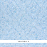 Tortola Paperweave blue diamond geometric woven wallpaper by Schumacher, shown in close-up and installed in a bathroom setting.