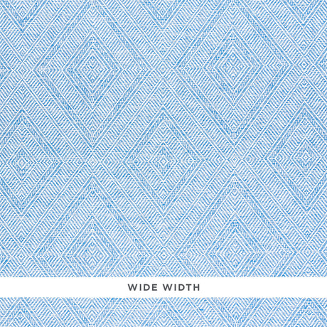 Tortola Paperweave blue diamond geometric woven wallpaper by Schumacher, shown in close-up and installed in a bathroom setting.