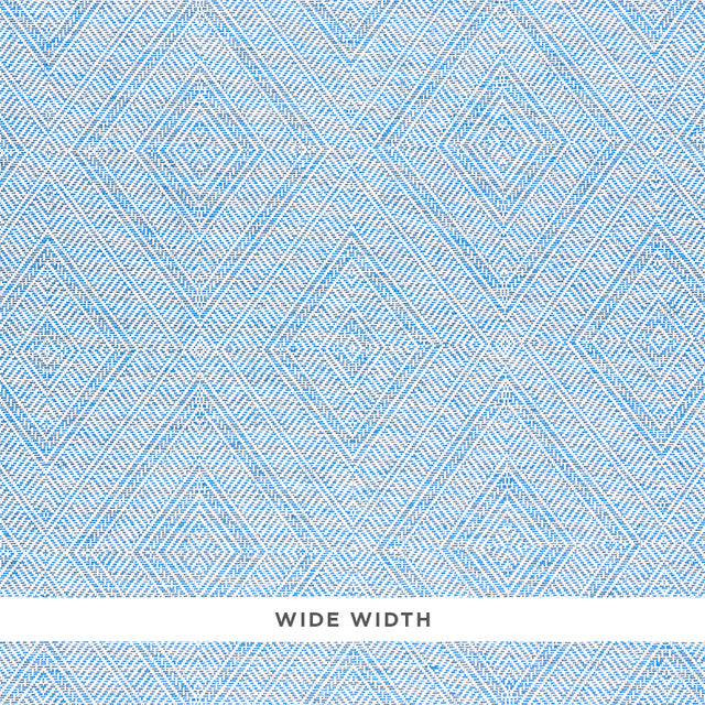 Tortola Paperweave blue diamond geometric woven wallpaper by Schumacher, shown in close-up and installed in a bathroom setting.