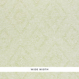 Tortola Paperweave green diamond geometric woven wallpaper by Schumacher, shown in close-up and installed in a bathroom.