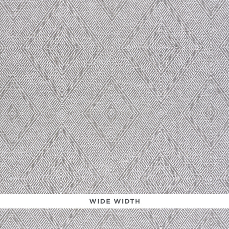 Tortola Paperweave wallpaper in grey with a diamond woven pattern, shown in detail and installed in a modern bedroom interior.