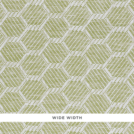 ABACO PAPERWEAVE green hexagonal woven wallcovering by Schumacher, shown in close-up and installed in a bedroom setting.