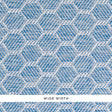 ABACO PAPERWEAVE blue hexagonal woven wallcovering by Schumacher shown in close-up and installed in a bedroom setting.