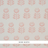 Rosenborg Pink stylized tulip hand block print wallpaper by Schumacher, shown in a modern nursery setting.