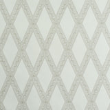 LES LOSANGES TOILE wallpaper in Stone by Schumacher, featuring a trellis and lozenge motif inspired by antique etchings, shown in a bathroom setting.