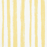 Sketched Stripe yellow hand-painted vertical stripe wallpaper by Schumacher, shown in close-up and styled room setting.