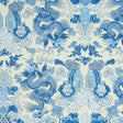 Blue and white wallpaper featuring dragons and foo dogs in a symmetrical, adventurous design. MAGIC MOUNTAIN DRAGON by Schumacher.