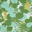 Painterly sea grapes and palm leaves in green and yellow on Schumacher SEA GRAPES wallpaper in Palm colorway, shown in a bright, sunlit room.