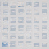 Tiasquam Sky by Caroline Z Hurley for Schumacher. Abstract hand-blocked look wallpaper in soft blue on white, shown in a modern living room setting.
