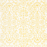 TIANA Yellow Bohemian Embroidered-Look Wallpaper by Schumacher, shown in a kitchen setting with gold fixtures and white shelving.
