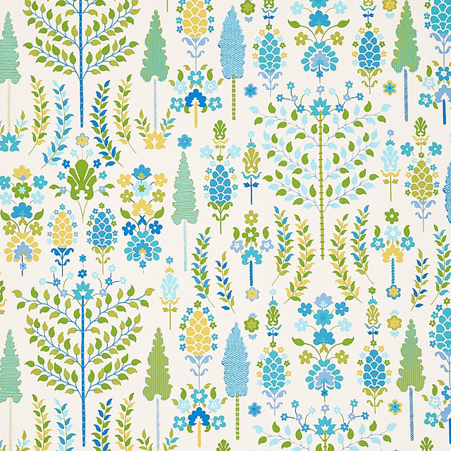 DESNA wallpaper in Peacock by Schumacher, whimsical folk-art inspired forest and floral pattern in blue, green, and yellow tones, shown in a bright bathroom setting.