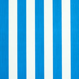 Edwin Stripe Medium wallpaper in cobalt blue and white, featuring bold vertical stripes and subtle texture, styled in a modern bedroom setting.