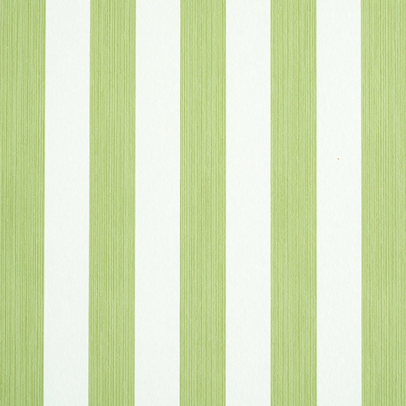 Edwin Stripe Medium wallpaper in Leaf by Schumacher, a green and white vertical stripe wallcovering shown in detail and in a styled bedroom setting.