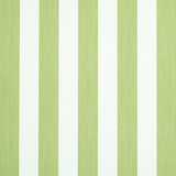 Edwin Stripe Medium wallpaper in Leaf by Schumacher, a green and white vertical stripe wallcovering shown in detail and in a styled bedroom setting.
