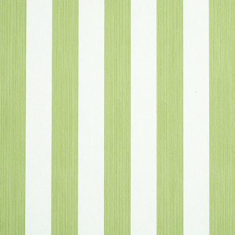 Edwin Stripe Medium wallpaper in Leaf by Schumacher, a green and white vertical stripe wallcovering shown in detail and in a styled bedroom setting.