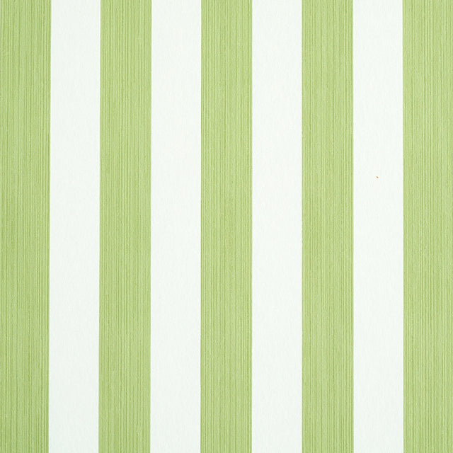 Edwin Stripe Medium wallpaper in Leaf by Schumacher, a green and white vertical stripe wallcovering shown in detail and in a styled bedroom setting.