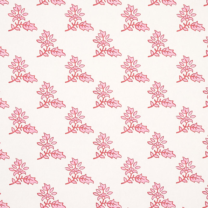 Torbay Pink wallpaper by Schumacher, featuring a repeating hand-blocked floral motif in pink on a white background.