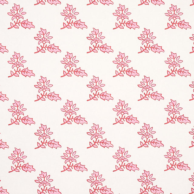 Torbay Pink wallpaper by Schumacher, featuring a repeating hand-blocked floral motif in pink on a white background.