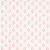 Aditi Blush by Schumacher, a petite stylized floral wallpaper in blush pink on white, shown in detail and installed in a bright, classic interior.