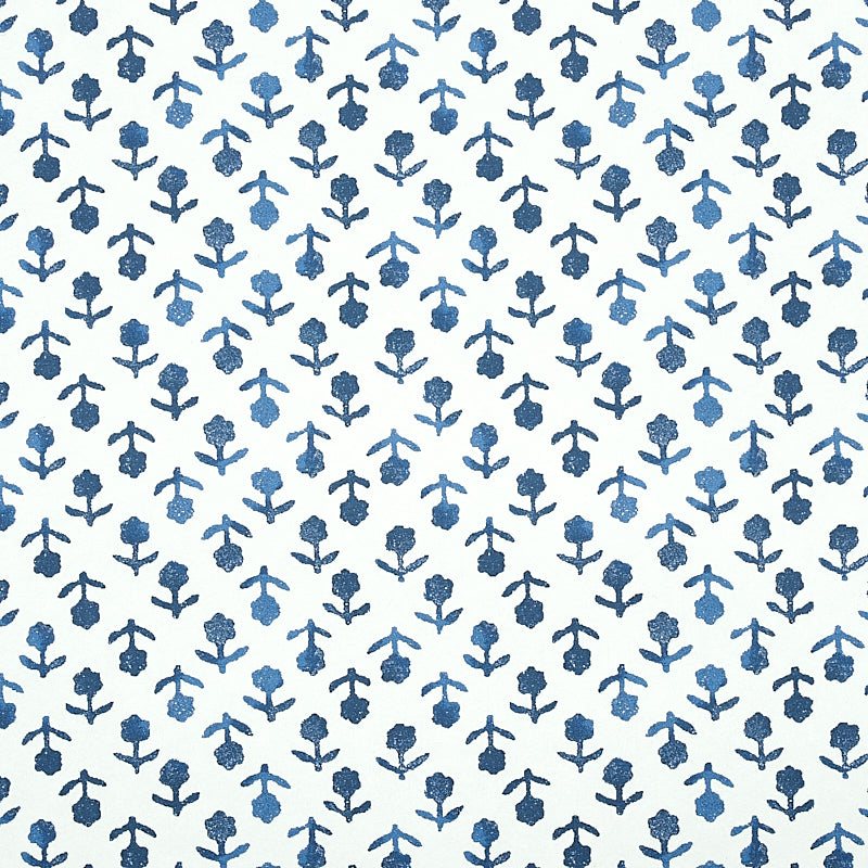 Beatriz Indigo by Schumacher, a diminutive printed floral wallpaper inspired by traditional indigo resist-dye techniques, shown in a bathroom setting.