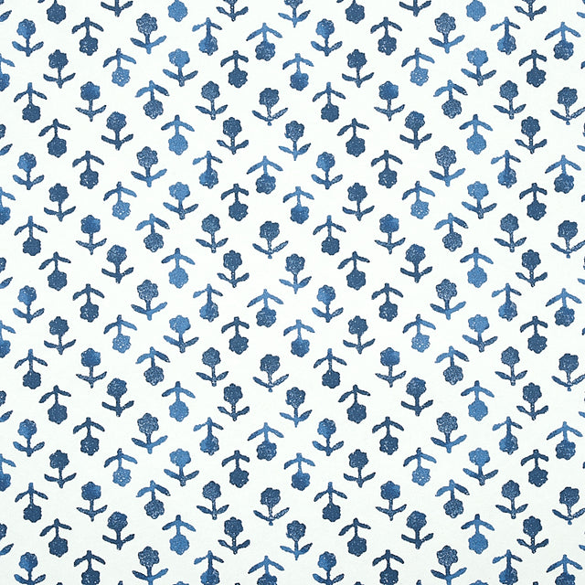 Beatriz Indigo by Schumacher, a diminutive printed floral wallpaper inspired by traditional indigo resist-dye techniques, shown in a bathroom setting.