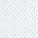 Beatriz Sky by Schumacher, a delicate blue floral wallpaper inspired by indigo resist-dye techniques, shown in a bathroom interior and as a roll.