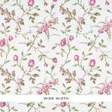 Magenta floral wallpaper with scattered roses and green leaves on a white background, Schumacher BELUZE