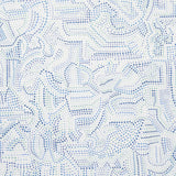 Galina wallpaper by Schumacher features a mosaic of abstract blue shapes reminiscent of antique tiles, shown in a modern bedroom setting.