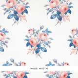 Loudon Rose wallpaper by Schumacher features painterly bouquets of pink roses and blue leaves on a white background.