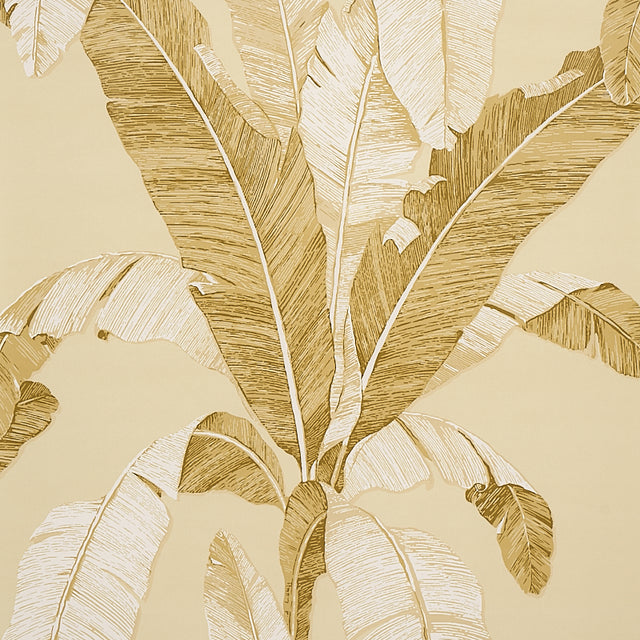 Large-scale neutral banana leaf wallpaper from Schumacher's Copacabana collection, shown in a styled interior setting.