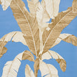Large-scale banana leaf blue wallpaper from Schumacher's Copacabana collection, Erisimo pattern, shown in a styled interior.