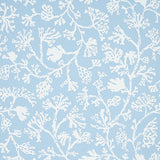 ANTHOZA wallpaper in Sky by Schumacher features a white botanical coral pattern on a light blue background, shown in detail and in a styled bedroom setting.
