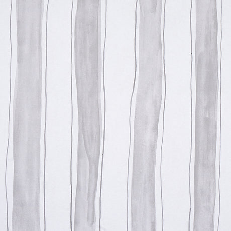 Tracing Stripes wallpaper in grey by Porter Teleo for Schumacher, featuring hand-painted vertical stripes in a modern bedroom setting.