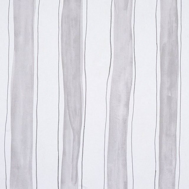 Tracing Stripes wallpaper in grey by Porter Teleo for Schumacher, featuring hand-painted vertical stripes in a modern bedroom setting.