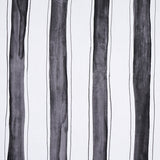 Tracing Stripes wallpaper by Schumacher, featuring bold hand-painted black vertical stripes with delicate tracing on a white background.