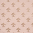 Rubia Blush wallpaper by Schumacher featuring stylized metallic floral motifs on a blush pink background, shown in a bathroom setting.