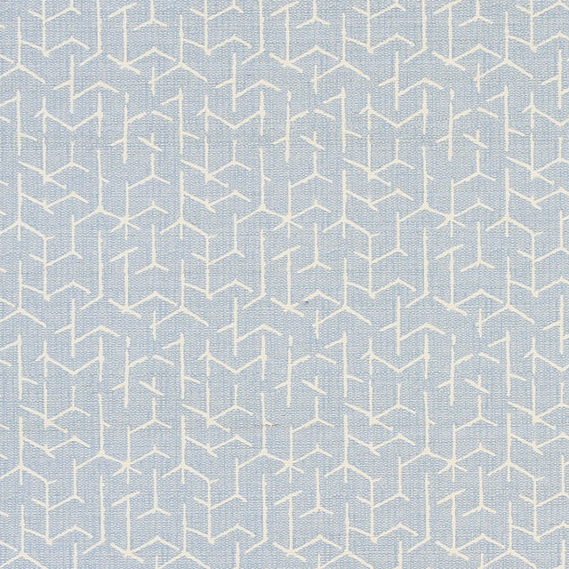 Coleridge Chambray by Schumacher - geometric blue and white wallpaper with a woven fabric texture, shown in a modern living room setting.