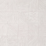 Katama wallpaper by Caroline Z Hurley for Schumacher, featuring an ivory-on-stone linear block pattern with artistic brushwork.