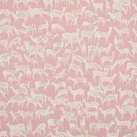 Miniature herds of hand-drawn deer in white on a dusty pink background, Fauna wallpaper by Schumacher, styled in a modern bedroom.