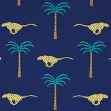 A Wild Desert Dream wallpaper in Midnight by Schumacher featuring cheetahs and palm trees on a deep blue background.
