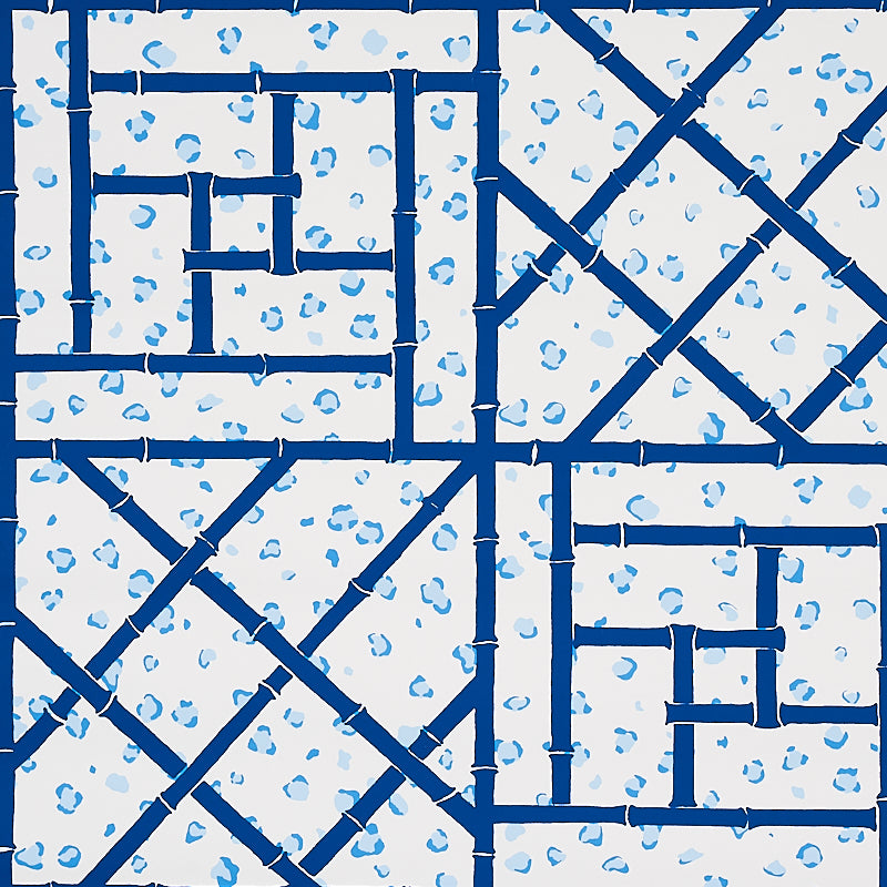 Fancy Beast Indigo wallpaper by Cristina Buckley for Schumacher, featuring a blue trellis and leopard spot pattern.
