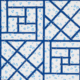 Fancy Beast Indigo wallpaper by Cristina Buckley for Schumacher, featuring a blue trellis and leopard spot pattern.