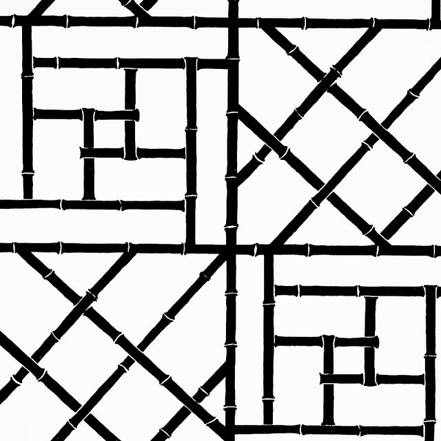 Trellis black bamboo fretwork geometric wallpaper by Cristina Buckley for Schumacher shown in a modern entryway