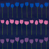 Edie Electric Jewel wallpaper by Cristina Buckley for Schumacher, featuring rows of stylized blue, pink, and purple tulip flowers on a dark background.